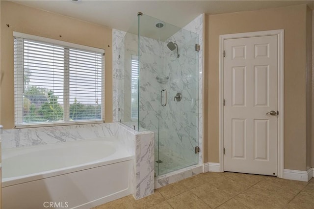 bathroom featuring shower with separate bathtub and tile patterned flooring