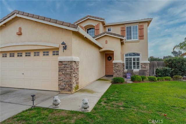 mediterranean / spanish house with a front yard and a garage