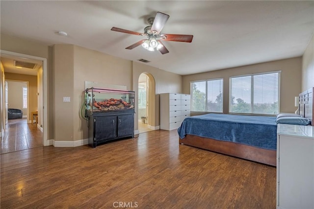 bedroom with wood-type flooring, ensuite bath, and ceiling fan