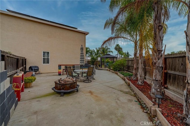 view of patio with a gazebo and a fire pit