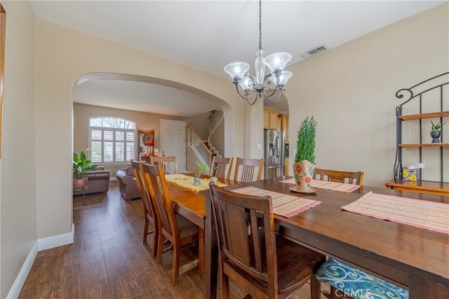 dining space with a chandelier and dark wood-type flooring