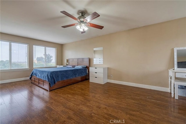 unfurnished bedroom featuring ceiling fan and dark hardwood / wood-style floors