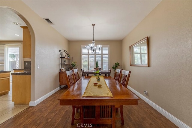 dining room featuring light hardwood / wood-style floors and a notable chandelier