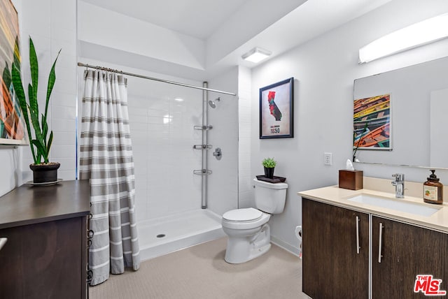 bathroom featuring curtained shower, toilet, and vanity