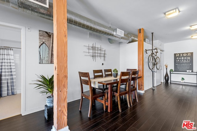 dining space featuring dark wood-type flooring