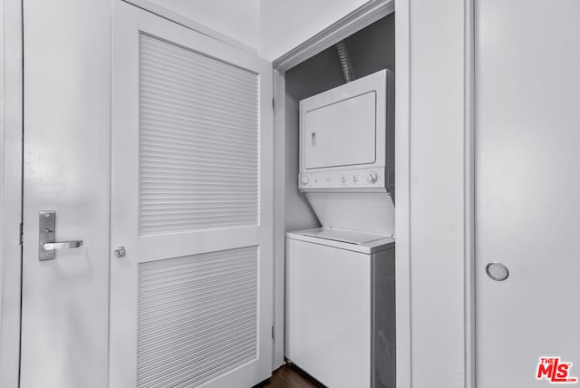 clothes washing area featuring stacked washer / drying machine