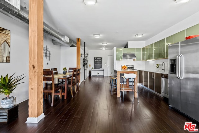 dining room with sink and dark hardwood / wood-style floors