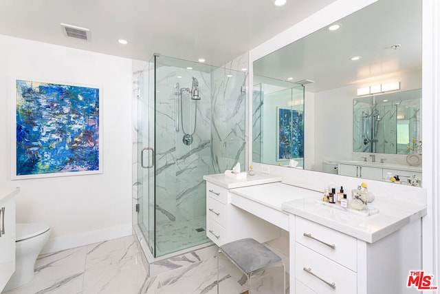 bathroom featuring vanity, toilet, and an enclosed shower