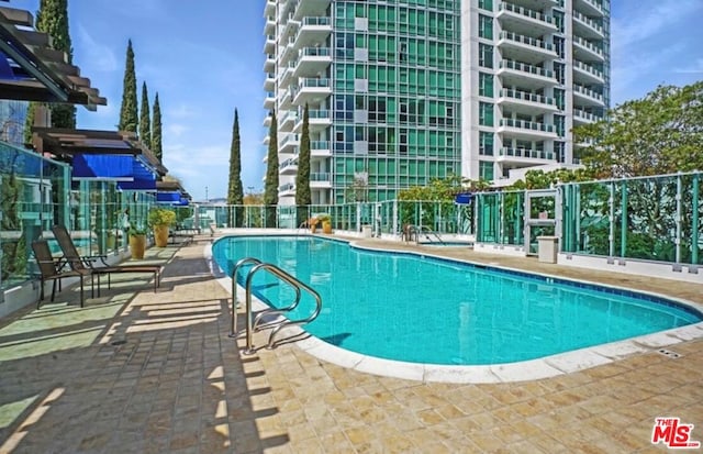 view of pool featuring a patio area