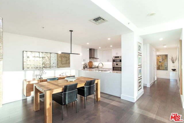 dining area featuring sink and dark hardwood / wood-style floors