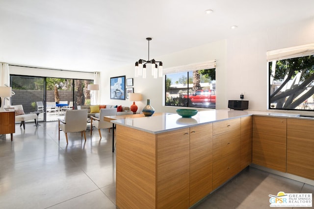 kitchen with decorative light fixtures, a chandelier, and kitchen peninsula