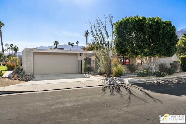 view of front of home featuring a mountain view and a garage