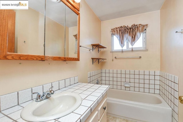 bathroom with a tub to relax in and vanity