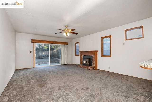 unfurnished living room with ceiling fan and carpet