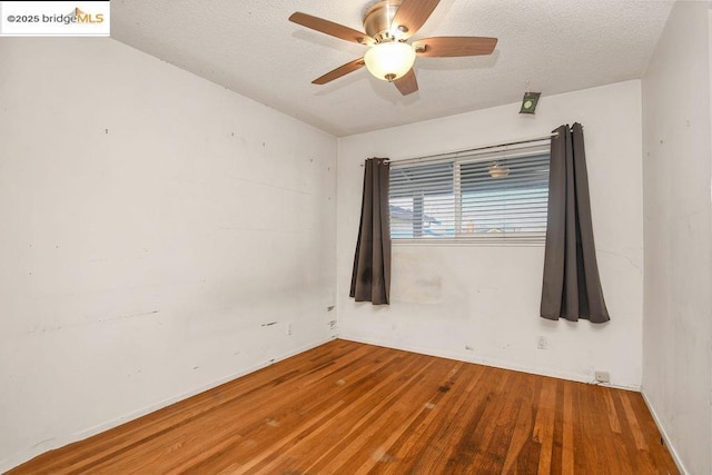 unfurnished room with hardwood / wood-style flooring, a textured ceiling, and ceiling fan