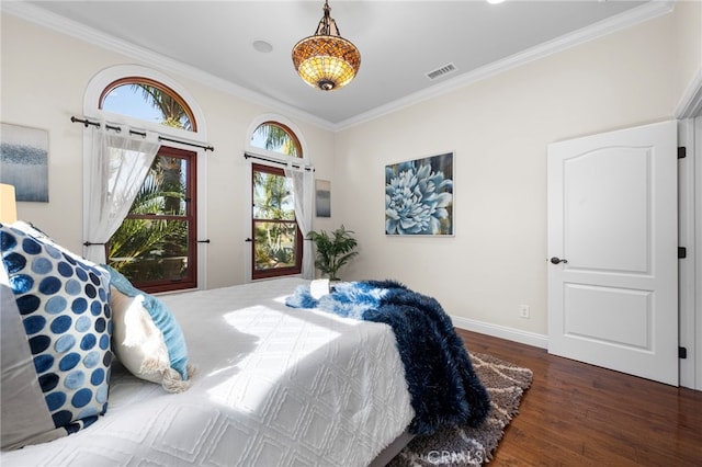 bedroom featuring dark wood-type flooring and ornamental molding