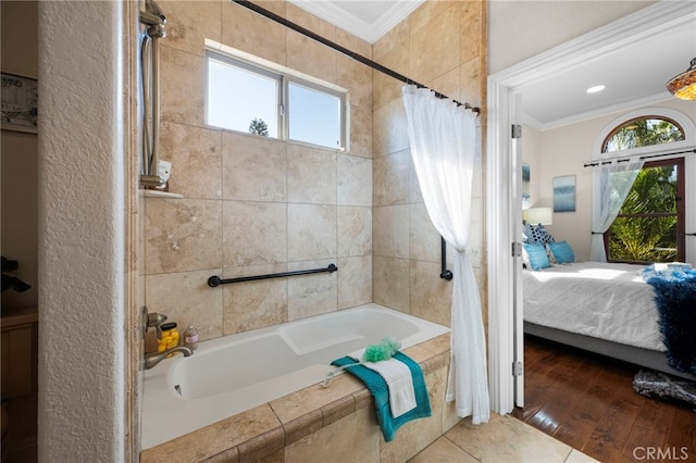 bathroom featuring hardwood / wood-style flooring, shower / tub combo with curtain, and ornamental molding