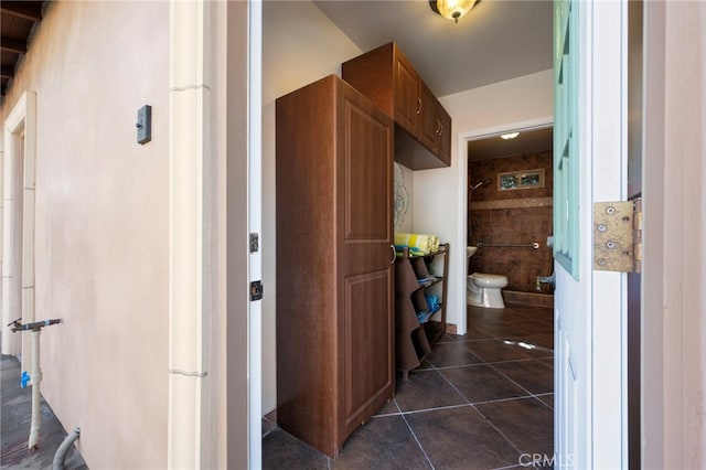 bathroom with toilet and tile patterned flooring