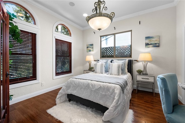 bedroom with crown molding and dark hardwood / wood-style floors