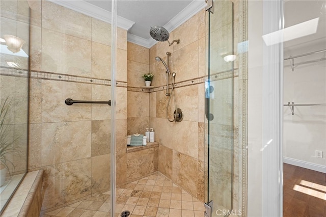 bathroom featuring a shower with shower door and crown molding