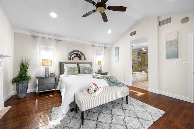 bedroom featuring lofted ceiling, dark hardwood / wood-style floors, ensuite bath, and ceiling fan