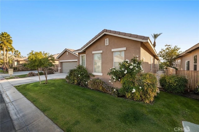 view of front of property with a garage and a front yard