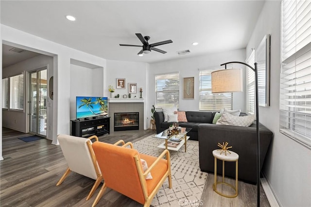 living area featuring visible vents, a tile fireplace, ceiling fan, wood finished floors, and recessed lighting