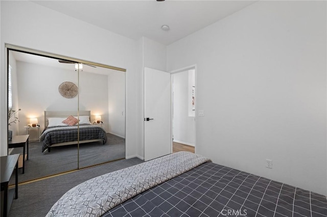 bedroom with carpet floors, a closet, and a ceiling fan