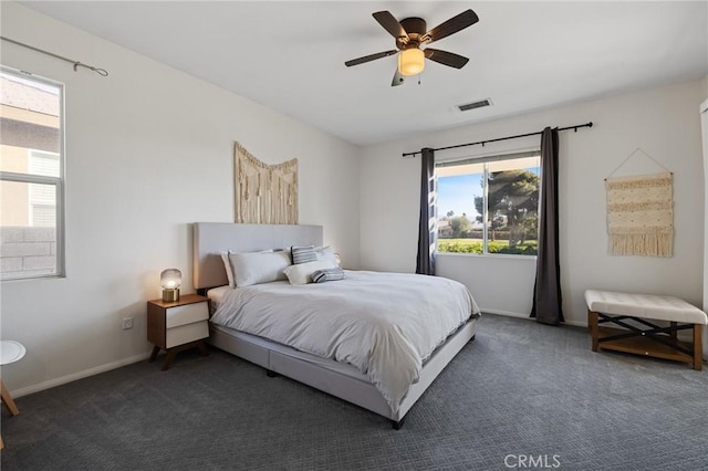 carpeted bedroom featuring visible vents, ceiling fan, and baseboards