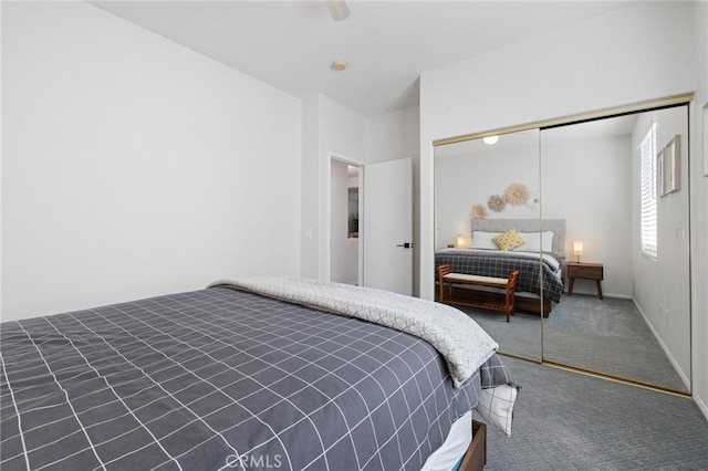 carpeted bedroom with ceiling fan, a closet, and baseboards