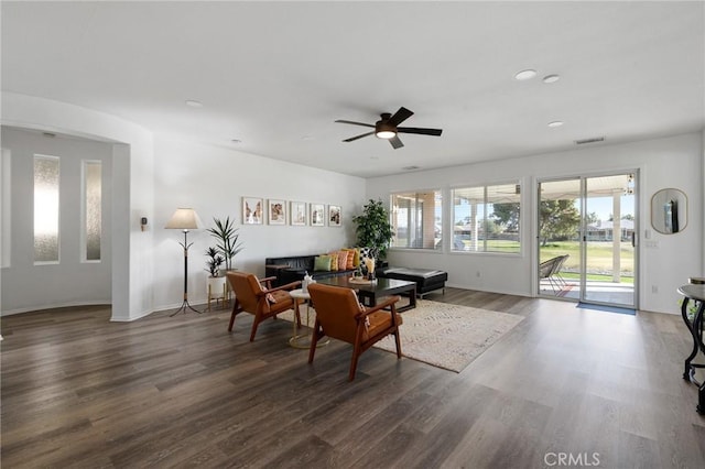 living room with ceiling fan, recessed lighting, visible vents, baseboards, and dark wood finished floors