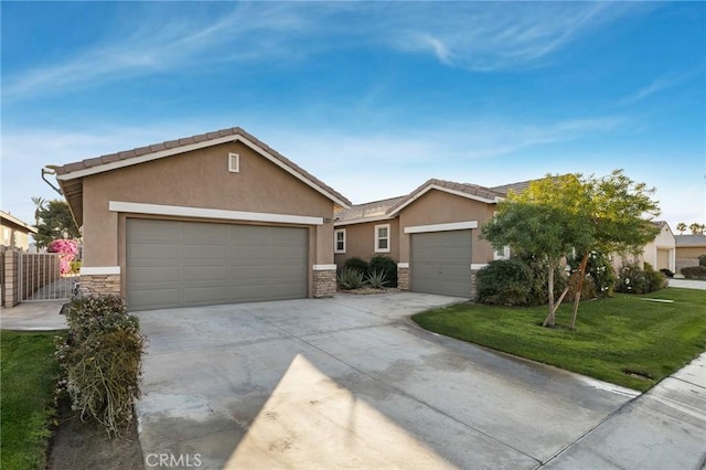 single story home with a garage, concrete driveway, stone siding, a front lawn, and stucco siding