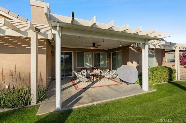 rear view of property featuring a lawn, a ceiling fan, a patio, a pergola, and stucco siding