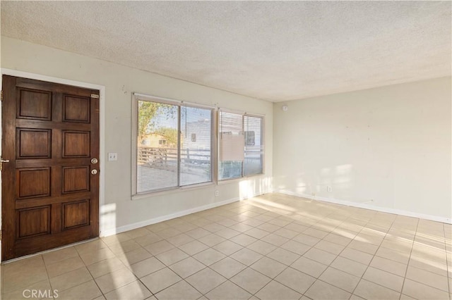 tiled entryway with a textured ceiling