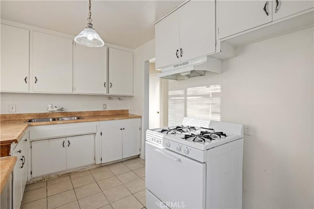 kitchen featuring pendant lighting, white cabinetry, sink, white gas range oven, and light tile patterned floors