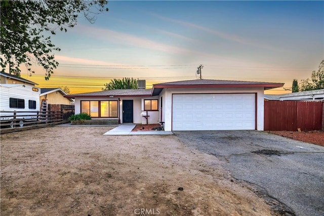 ranch-style house with cooling unit and a garage