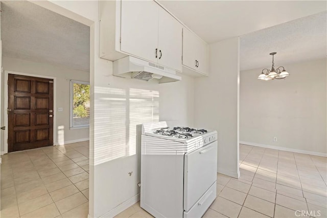 kitchen featuring decorative light fixtures, white cabinets, white gas range oven, and light tile patterned flooring