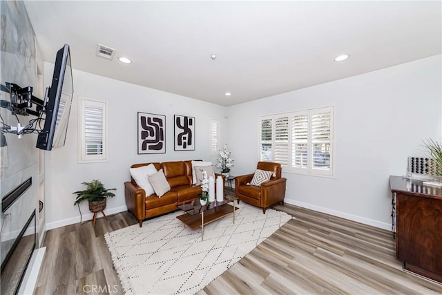 sitting room featuring a fireplace and hardwood / wood-style flooring