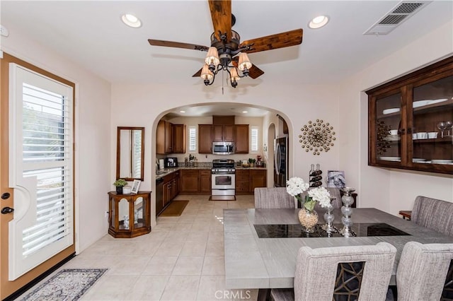 tiled dining area with ceiling fan