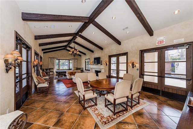 tiled dining space with french doors, vaulted ceiling with beams, plenty of natural light, and an inviting chandelier