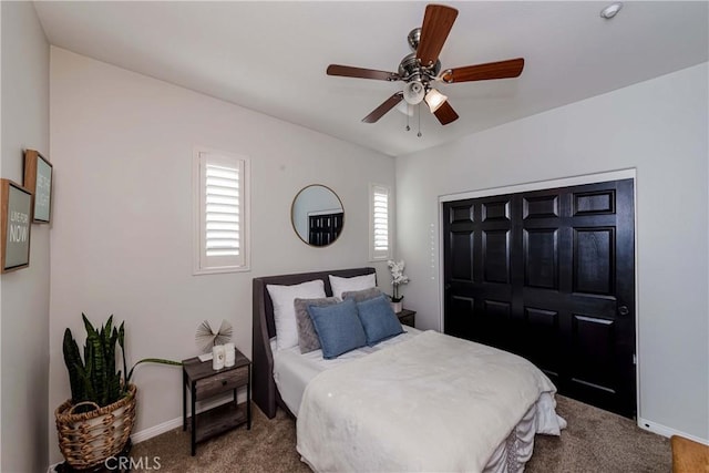 carpeted bedroom with a closet and ceiling fan