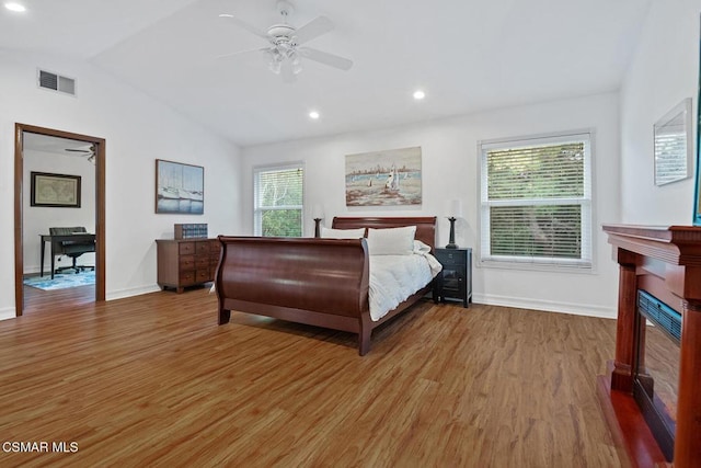 bedroom featuring hardwood / wood-style flooring, ceiling fan, and vaulted ceiling