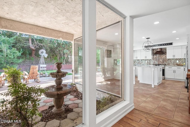 sunroom / solarium featuring an inviting chandelier