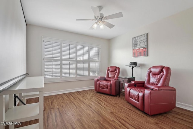 sitting room with hardwood / wood-style flooring and ceiling fan