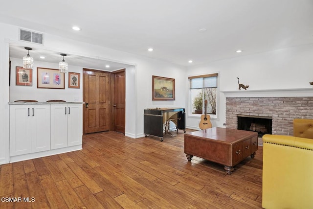 living room with a fireplace and light hardwood / wood-style flooring