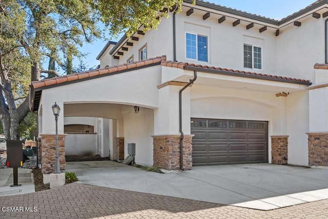 mediterranean / spanish house featuring a garage