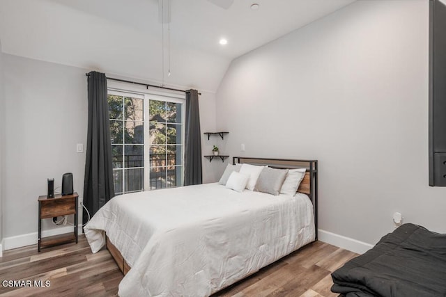 bedroom featuring hardwood / wood-style flooring and vaulted ceiling