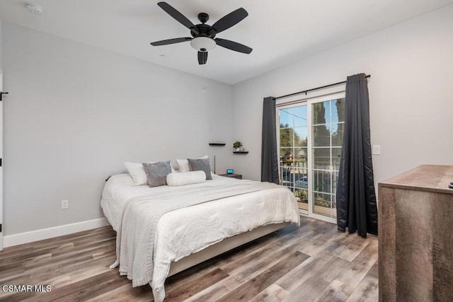 bedroom with hardwood / wood-style flooring, ceiling fan, and access to exterior