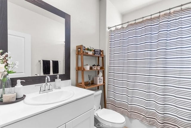 bathroom featuring vanity, a shower with curtain, and toilet