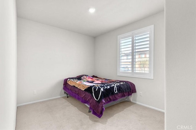 bedroom featuring light carpet